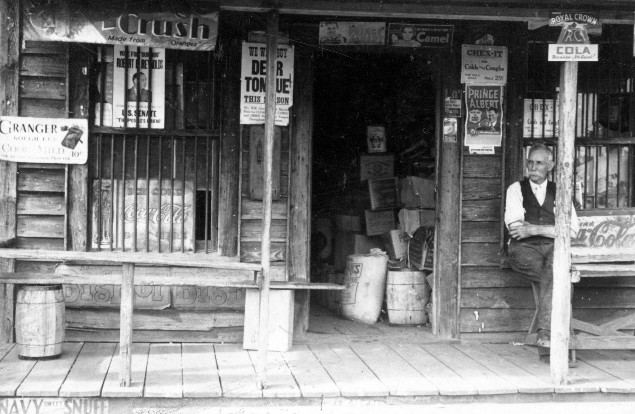 Charles Corbett at his general store in Ivanhoe, N.C., 1938. His was one of many Sampson County stores where wild blueberry foragers could exchange their berries for cash or credit. Wholesalers would then collect the berries and ship them by rail to Washington, New York City, and even Boston. Photo courtesy, State Archives of North Carolina