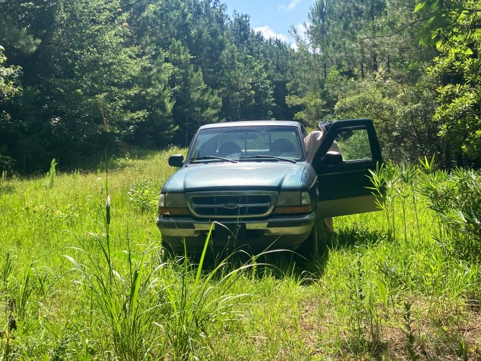 Mary Katherine and her truck on the old cart path to the graveyard where Benjamin and Euphamy Hardesty are buried. Photo by David Cecelski