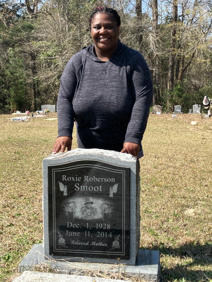 Local historian Latonya Jones standing by the burial place of her beloved grandmother, Roxie Roberson Smoot, in Hickman Hill, just west of Havelock, N.C. Photo by David Cecelski